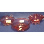 Three items of Victorian cranberry glass to include heart shaped dish with loop handle, another