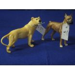 Goebel German porcelain standing boxer dog, together with a Beswick china lioness.  Both with