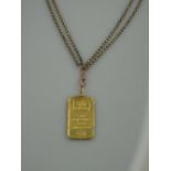 A SUISSE ONE TROY OUNCE FINE GOLD RECTANGULAR INGOT, mounted as a pendant on a rectangular Victorian