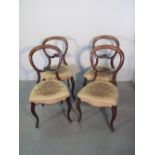 SET OF FOUR VICTORIAN WALNUT FRAMED BALLOON BACKED DINING CHAIRS with foliate moulded bars,