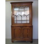 19th CENTURY WELSH OAK DOUBLE CORNER CUPBOARD having moulded cornice above mahogany frieze, single