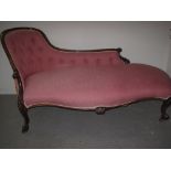 VICTORIAN ROSEWOOD SHOWFRAME SERPENTINE FRONTED CHAISE LONGUE having buttoned back, scrolled and
