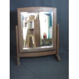 A BRYNMAWR ARTS AND CRAFTS OAK DRESSING-TABLE MIRROR, c. 1935, the rectangular bevelled glass