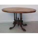 VICTORIAN CROSS BANDED OVAL WALNUT LOO TABLE, the top with quarter veneers, on a four column base