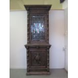 VICTORIAN CARVED OAK CABINET UPON CUPBOARD in continental style overall carved with relief lion