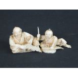 JAPANESE CARVED IVORY OKIMONO FIGURE GROUP depicting father and son slicing vegetables in