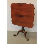 18th CENTURY MAHOGANY SERPENTINE TOPPED TRIPOD TABLE having gun-barrelled turned pedestal on three