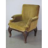 19th CENTURY GEORGIAN STYLE UPHOLSTERED LIBRARY CHAIR on foliate moulded and scrolled oak legs.