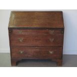 LATE GEORGIAN OAK FALL FRONT BUREAU, the fall revealing fitted interior over three graduated drawers