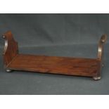 18th CENTURY YEW TABLE TOP BOOK STAND having solid scrolled ends standing on bun feet.  Possibly
