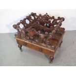 VICTORIAN WALNUT MUSIC CANTERBURY, having foliate scrolled divisions over a frieze draw, standing on
