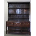 EARLY 19th CENTURY WELSH OAK POT BOARD DRESSER having stained three shelf boarded rack back.  The