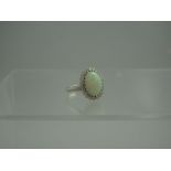 AN 18th CENTURY WHITE GOLD OPAL AND DIAMOND RING.  The oval opal measuring approximately 15mm x 10mm