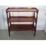 19th Century mahogany three tier dumb waiter having solid galleries, baluster turned gun barrel