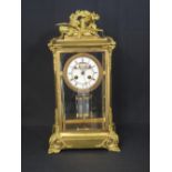 19th CENTURY ORMOLU GILT BRONZE FRENCH FOUR GLASS MANTLE CLOCK, the case with emblematic pediment