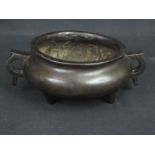 CHINESE PATINATED BRONZE BALUSTER SHAPED TWO HANDLED KORO OR BOWL ON THREE FEET.  Impressed