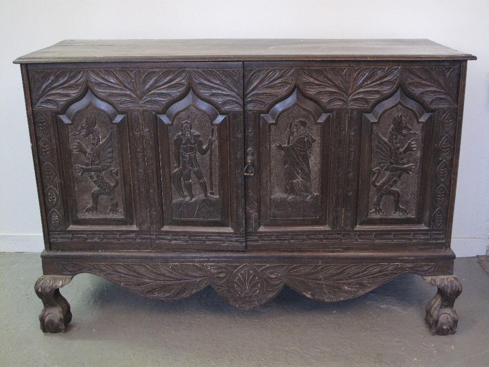A LARGE 18th CENTURY AND LATER WELSH OAK COFFER converted to a cupboard.  Later overall carved with
