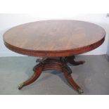 REGENCY ROSEWOOD CIRCULAR PILLAR DINING TABLE 
The top with bead moulded frieze, on a panelled