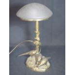 A YELLOW METAL SCULPTURAL LAMP BASE with frosted domed glass shade with arboreal column, the