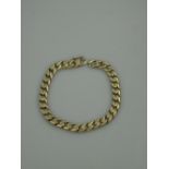 A 14CT GOLD FLATTENED CURB LINK BRACELET with integral clasp and safety catch.  Weight 37.8g. Length