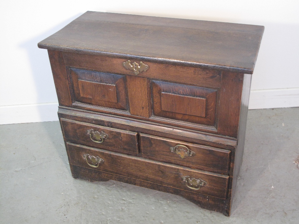 WELSH OAK COFFOR BACH in 18th Century style, having hinged cover above two raised and fielded