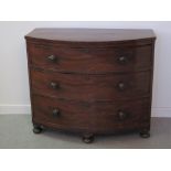 SMALL VICTORIAN MAHOGANY BOW FRONTED CHEST OF THREE GRADUATED AND COCK BEADED DRAWERS with turned