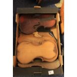 Box of assorted violin parts.