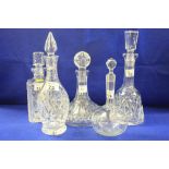 Group of five assorted cut and other glass decanters to include mallet shaped, square, ships type,