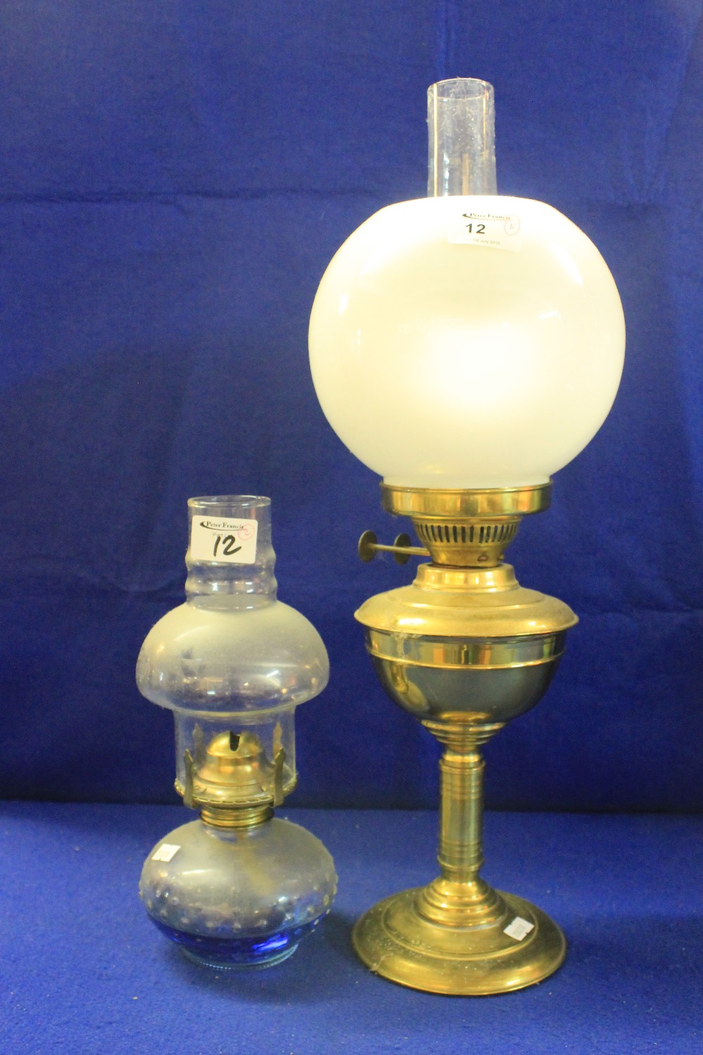 Early 20th Century brass double burner oil lamp together with similar smaller version with blue