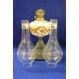 Early 20th Century oil lamp with floral cream, brown reservoir with two clear glass funnels.