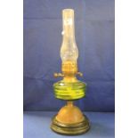 Early 20th Century double oil lamp with green glass reservoir.