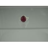 A 14ct GOLD RUBY AND DIAMOND RING.  The