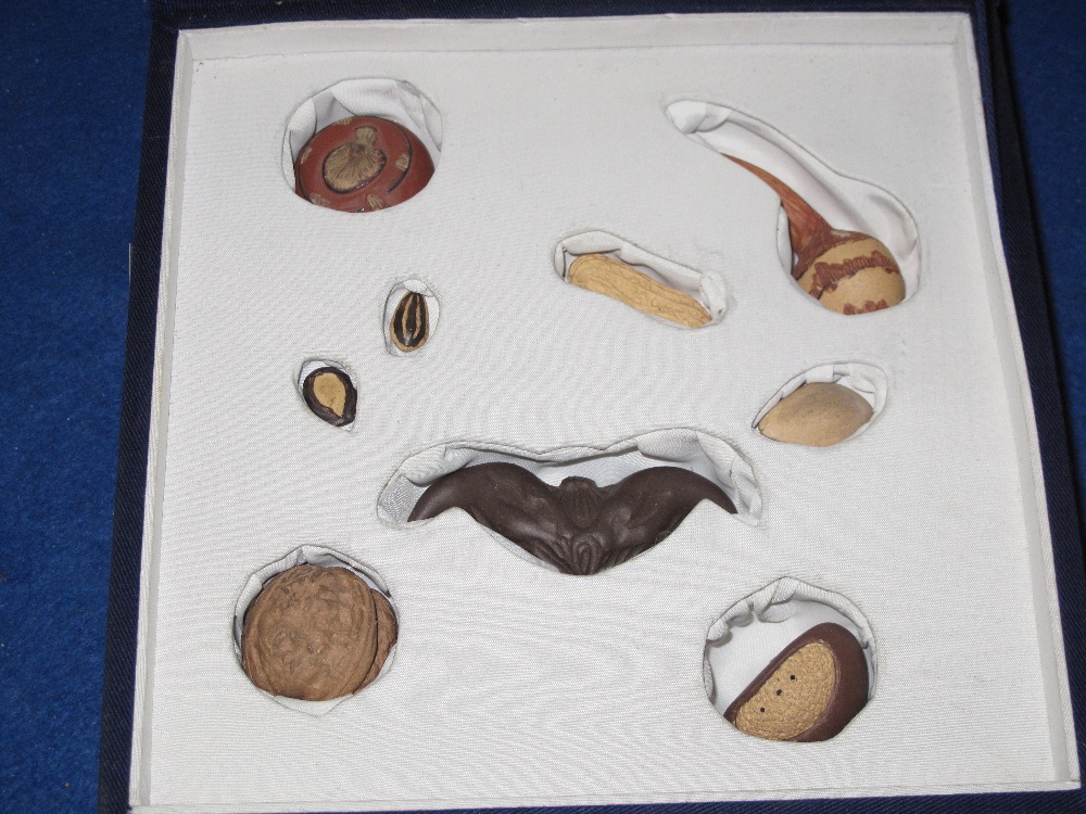 Fitted case containing a collection of Chinese ceramic models of nuts and seeds. - Image 2 of 2