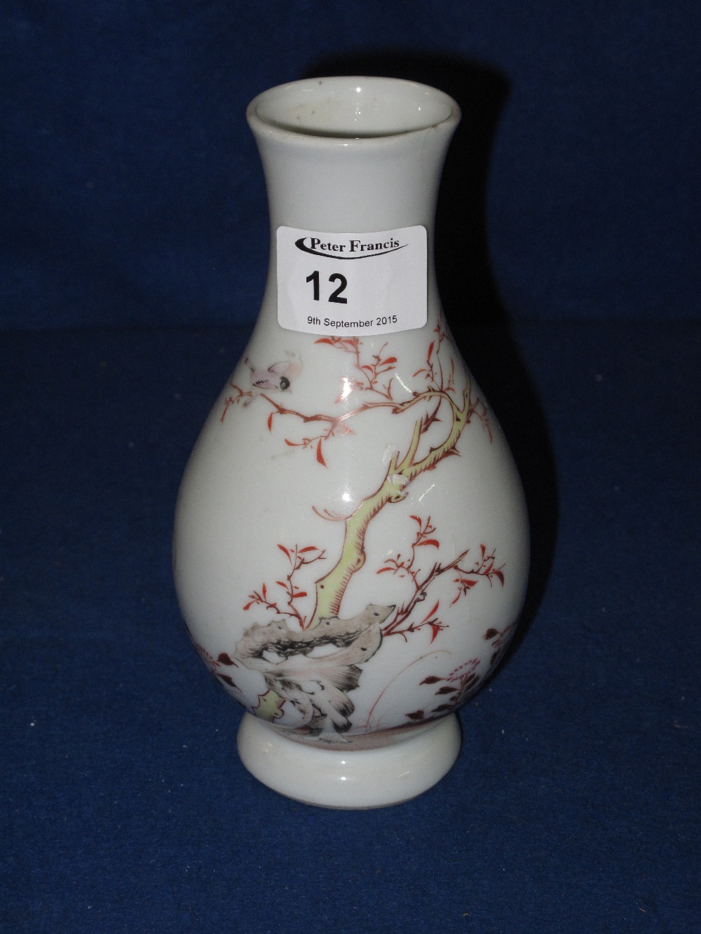 Chinese porcelain baluster shaped vase overall painted with foliage and butterflies on a white