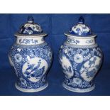 Pair of modern blue and white Chinese porcelain baluster shaped jars and covers with reserved