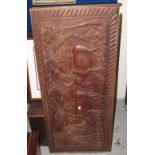 African carved wooden panel depicting oxen with figure.