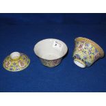 Pair of Chinese porcelain tea bowls overall decorated in coloured enamels on a yellow ground