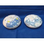 Two similar circular Japanese porcelain blue and white sectional jars with figural scenes. (2)