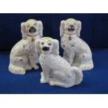 Pair of 19th century Staffordshire pottery over gilded white seated spaniels with free standing