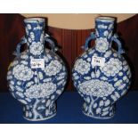Pair of chinese porcelain under glazed blue prunus blossom decorated two handled moon flasks with