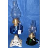 Early 20th Century single burner oil lamp with blue glass reservoir and cast metal base,