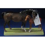 Beswick china mare and foal group, on rectangular base.  Printed mark with impressed number 1811.