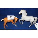 Beswick china Palomino foal and a Beswick china dapple grey pony.  Printed marks.  (2) CONDITION