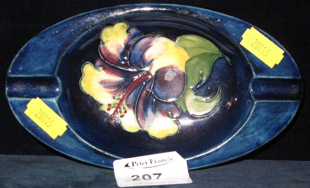 Moorcroft pottery blue ground oval ashtray with tube lined floral spray.