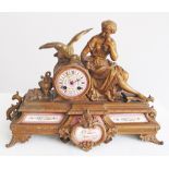 A French ormolu mantel clock with eight day movement striking on a bell, painted pink porcelain dial