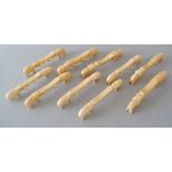 A group of ten late 19th / early 20th century carved ivory knife rests, featuring elephants