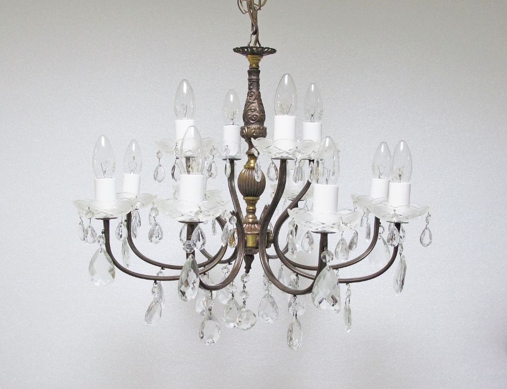 A continental, Victorian style 12 light two tier crystal chandelier, c1950, with patinated bronze