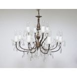 A continental, Victorian style 12 light two tier crystal chandelier, c1950, with patinated bronze