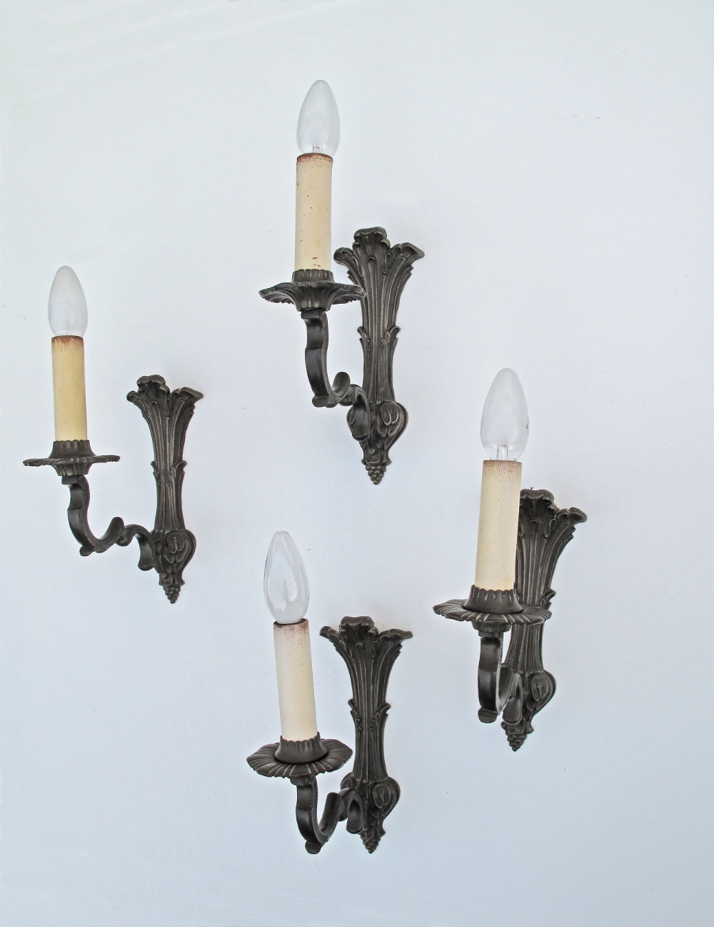 A set of four French style, exceptional quality, mid 20th century, patinated black bronze one arm