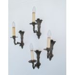 A set of four French style, exceptional quality, mid 20th century, patinated black bronze one arm